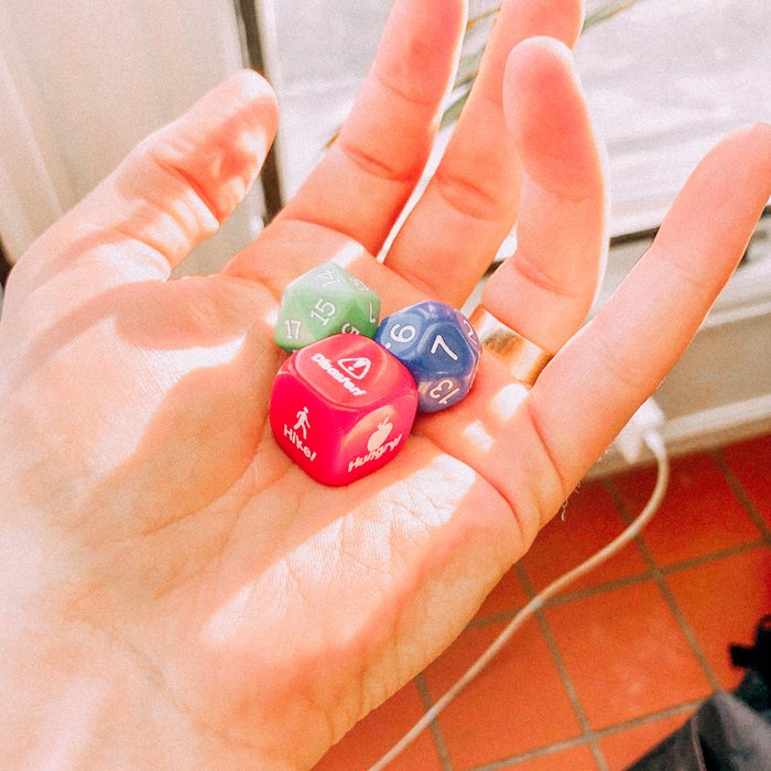 Holding a handful of custom Rough! dice